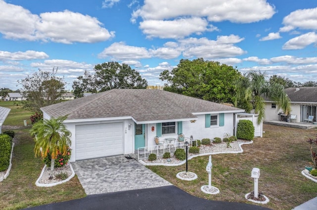 ranch-style home with a front yard and a garage