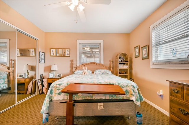 carpeted bedroom featuring ceiling fan, multiple windows, and a closet