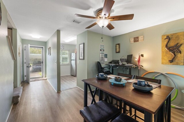 home office featuring light wood-type flooring and ceiling fan