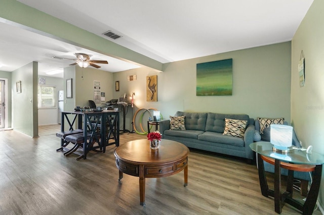 living room with wood-type flooring and ceiling fan