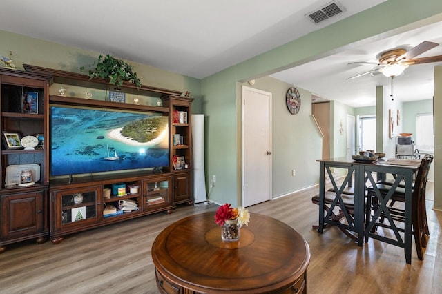 living room with hardwood / wood-style flooring and ceiling fan