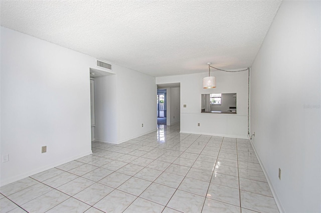 unfurnished room with a textured ceiling