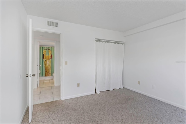 unfurnished bedroom with light colored carpet