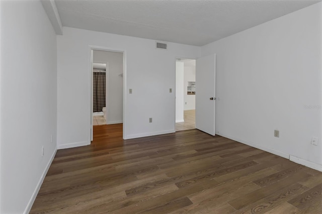 unfurnished bedroom with dark hardwood / wood-style floors