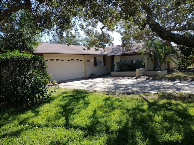 ranch-style house featuring a front yard and a garage