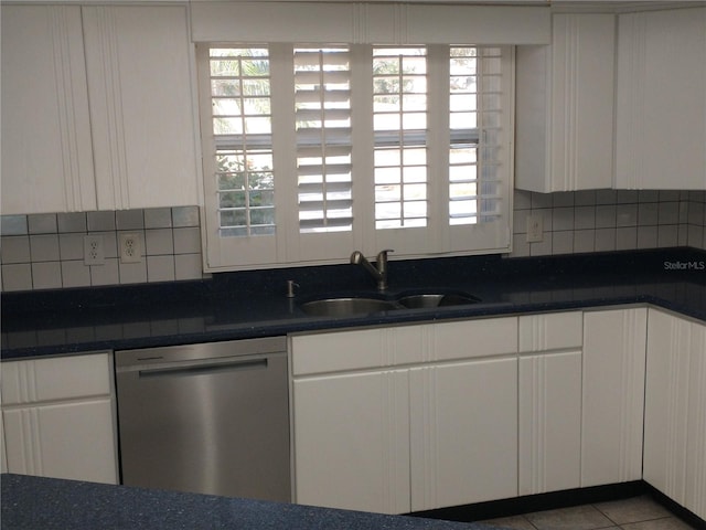 kitchen with stainless steel dishwasher, white cabinetry, and sink