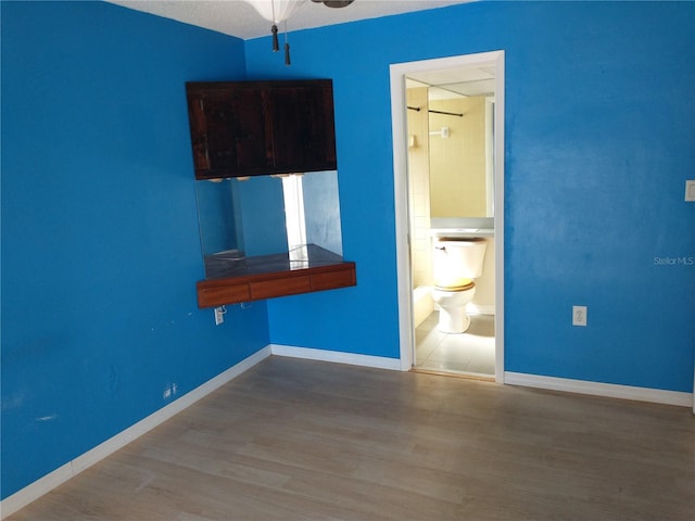 interior space with ceiling fan and hardwood / wood-style floors