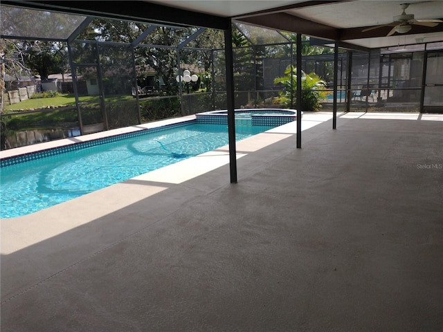 view of swimming pool with ceiling fan, a patio area, a lanai, and an in ground hot tub