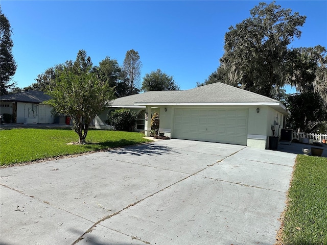 ranch-style home featuring a front lawn and a garage