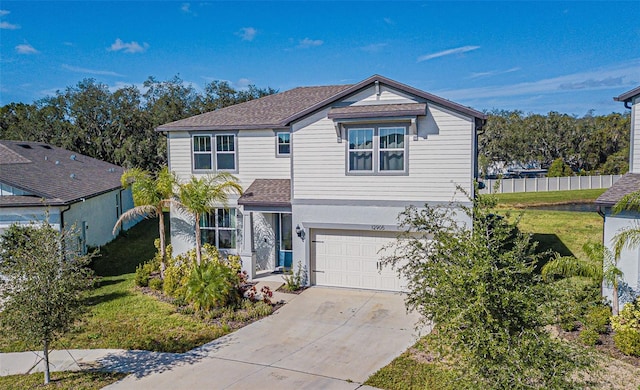 view of property with a front lawn and a garage