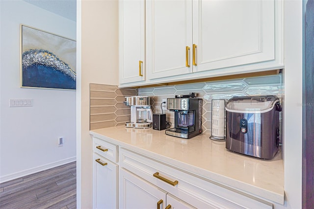 bar featuring tasteful backsplash, white cabinetry, and hardwood / wood-style floors