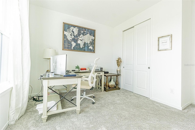 office area featuring light colored carpet