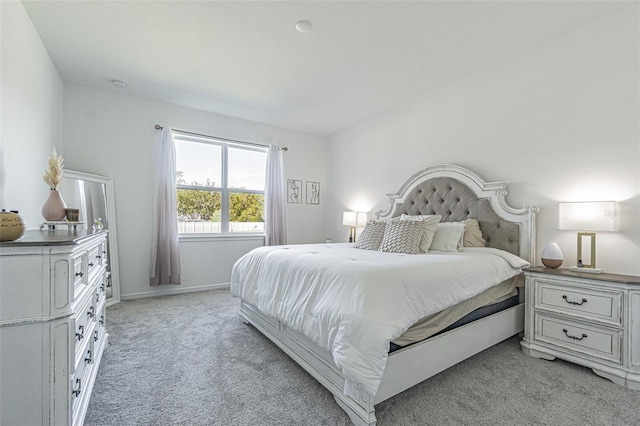 bedroom with light colored carpet