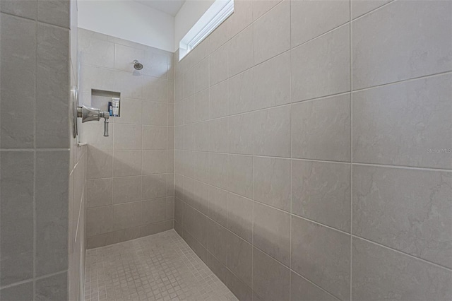 bathroom with tiled shower