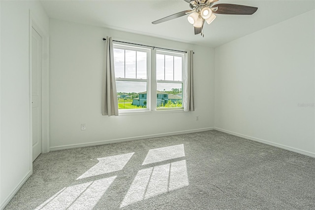 carpeted empty room featuring ceiling fan