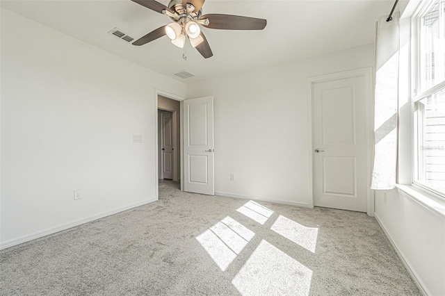 unfurnished bedroom featuring ceiling fan and light carpet