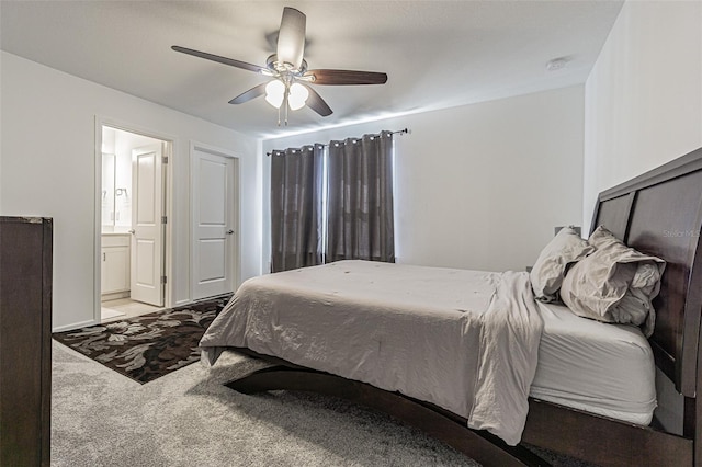 bedroom featuring light carpet, ensuite bath, and ceiling fan