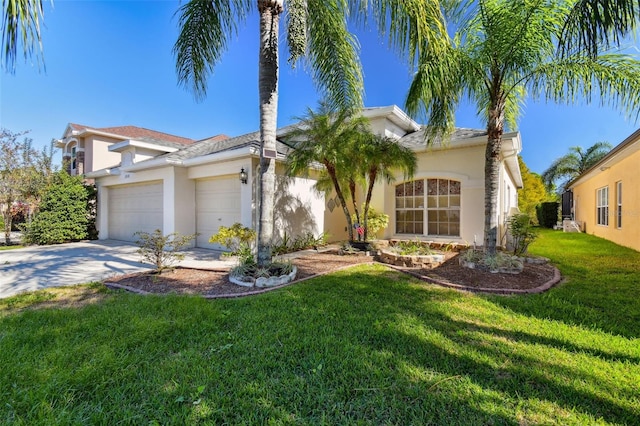 mediterranean / spanish-style house featuring a front yard and a garage