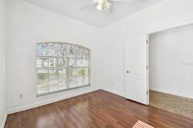 unfurnished room with dark hardwood / wood-style floors and ceiling fan