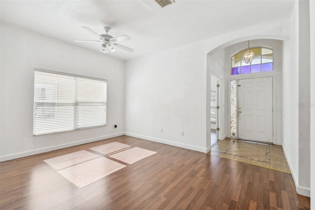 foyer with dark hardwood / wood-style floors and ceiling fan