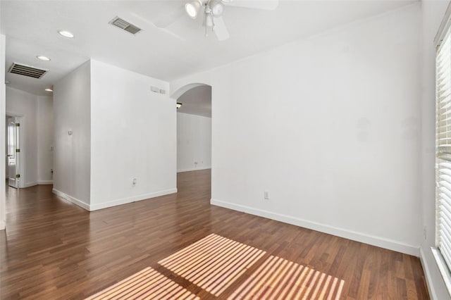 unfurnished room with dark hardwood / wood-style flooring and ceiling fan