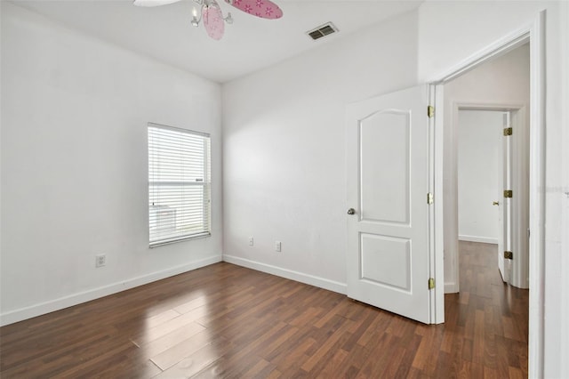 spare room featuring dark hardwood / wood-style floors and ceiling fan