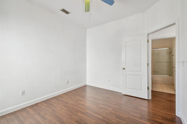 spare room with ceiling fan and dark wood-type flooring