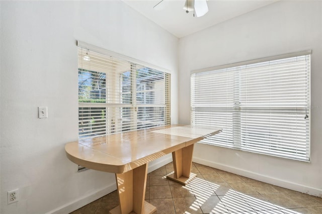 tiled dining area featuring ceiling fan