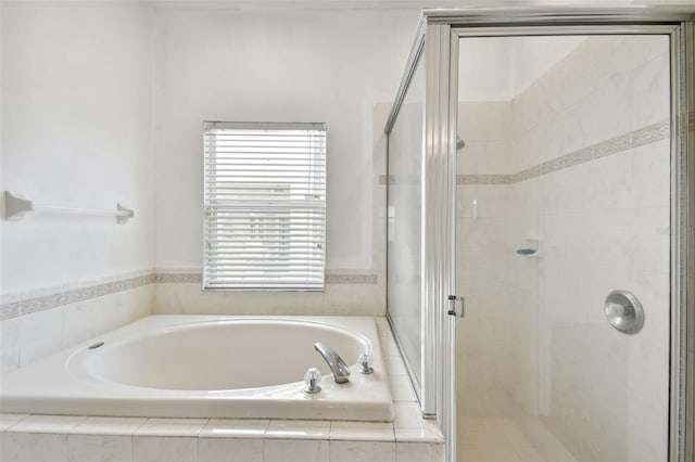 bathroom featuring separate shower and tub