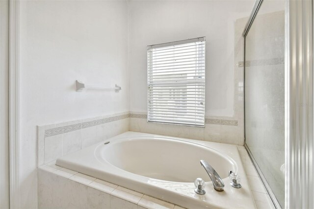 bathroom featuring tiled bath