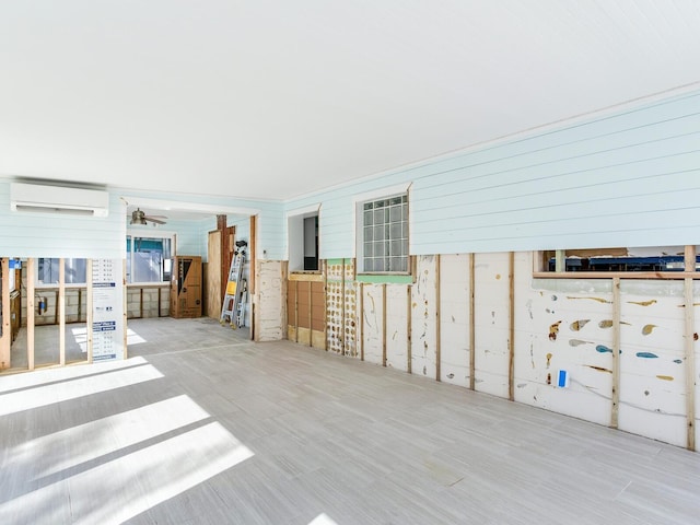 interior space with wood walls and a wall mounted AC