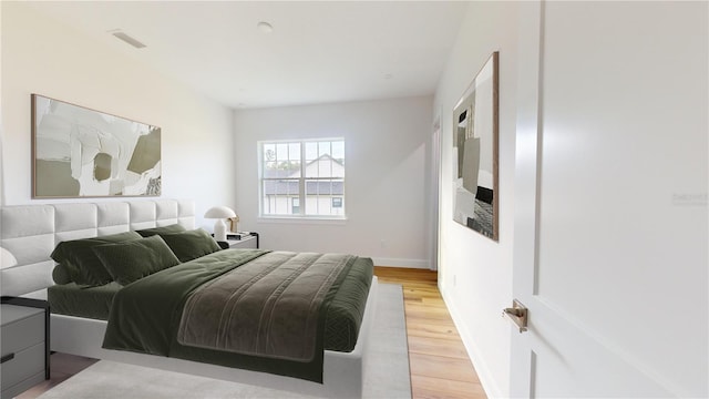 bedroom with light wood-type flooring, baseboards, and visible vents