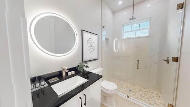 bathroom featuring toilet, vanity, and a marble finish shower