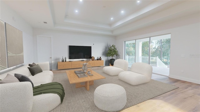 living area featuring visible vents, baseboards, a raised ceiling, wood finished floors, and recessed lighting