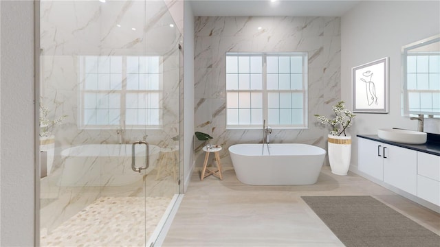 full bathroom with tile walls, a freestanding bath, vanity, and a marble finish shower