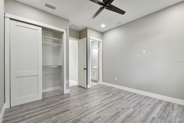 unfurnished bedroom featuring ceiling fan, a closet, and light hardwood / wood-style flooring