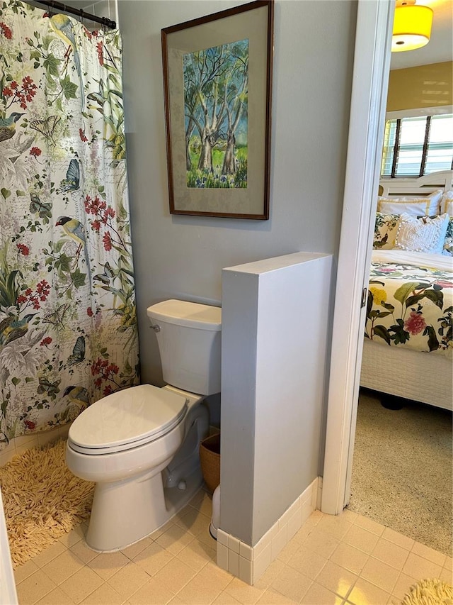 bathroom featuring toilet and walk in shower