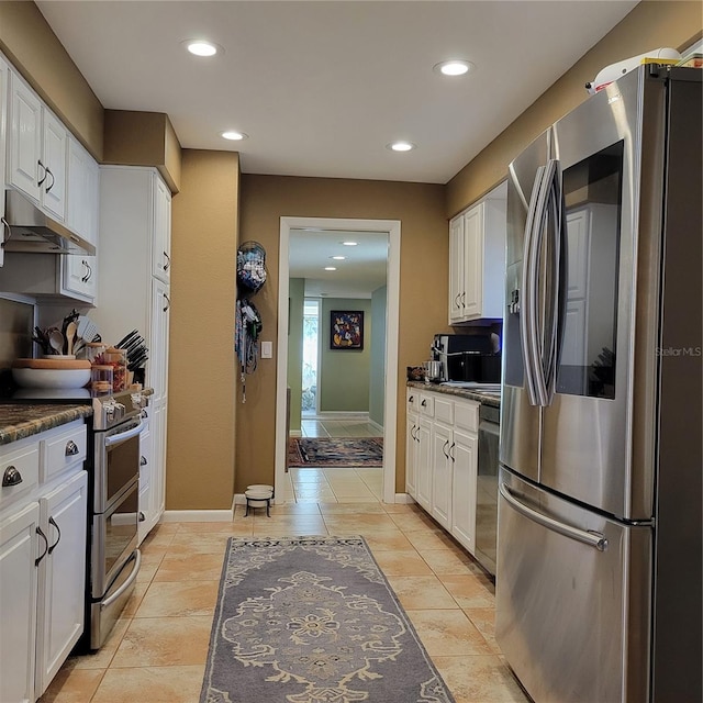 kitchen with white cabinets, light tile patterned floors, and stainless steel appliances