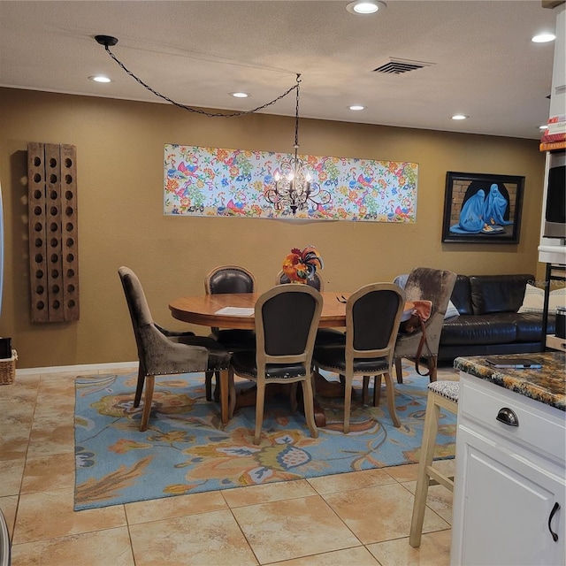 dining room featuring a chandelier, light tile patterned floors, and a textured ceiling