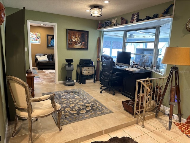 tiled home office with a textured ceiling