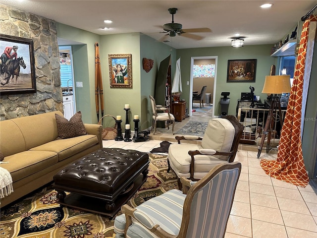 tiled living room featuring ceiling fan, sink, and a healthy amount of sunlight