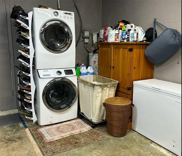 clothes washing area featuring stacked washer and clothes dryer