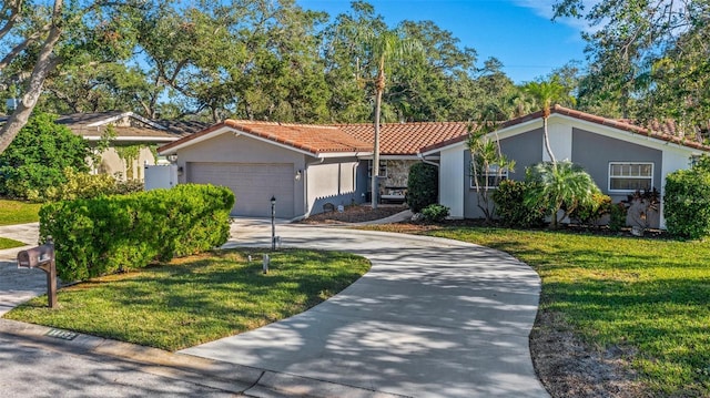 view of front of house with a garage and a front lawn