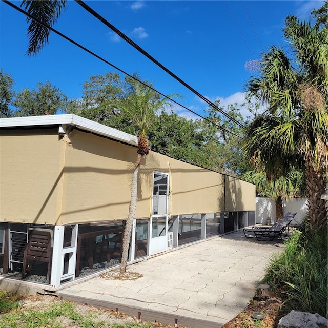 back of house with a patio area and stucco siding