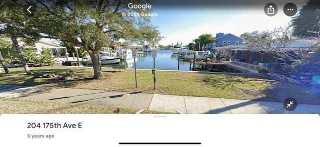 exterior space featuring a boat dock and a water view