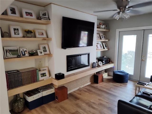 living room with french doors, ceiling fan, a healthy amount of sunlight, and light hardwood / wood-style floors