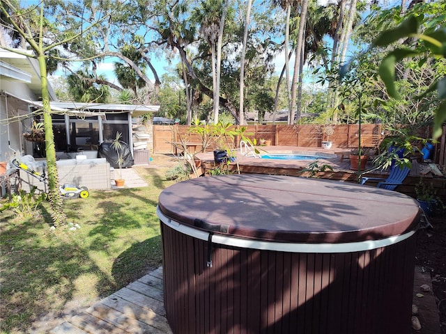 view of yard featuring a pool with hot tub