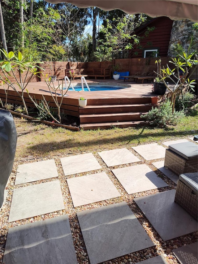 view of yard with a wooden deck and a patio