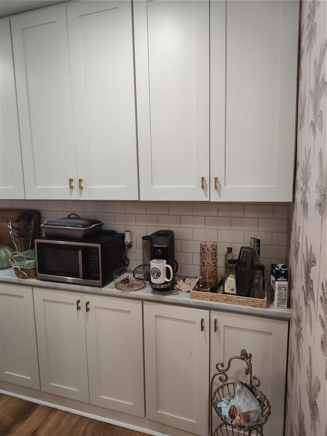 kitchen featuring white cabinetry and dark hardwood / wood-style flooring