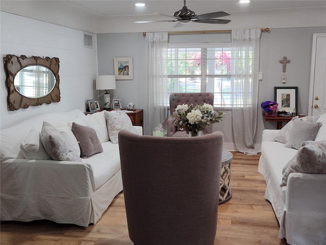 living room with ceiling fan and light hardwood / wood-style flooring